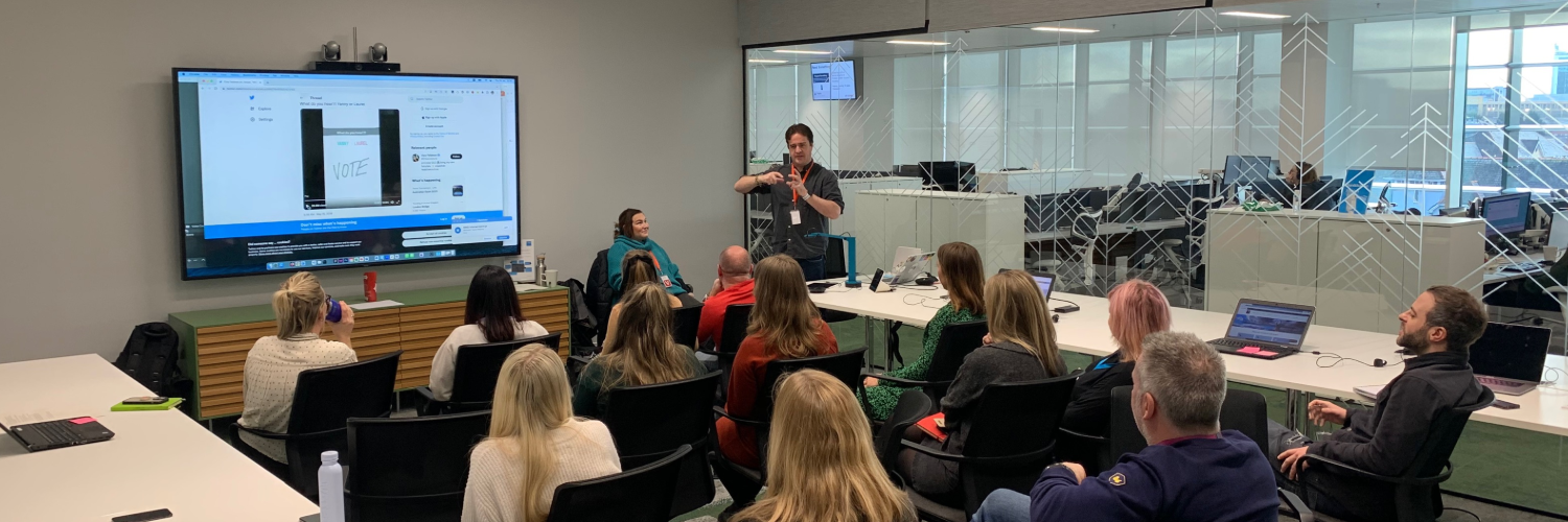 Chris Bush speaks to a room of seated people