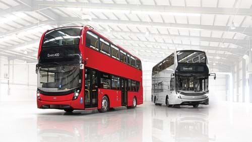 A large red double decker bus turned to the left, and a silver double decker bus, turned to the right. 