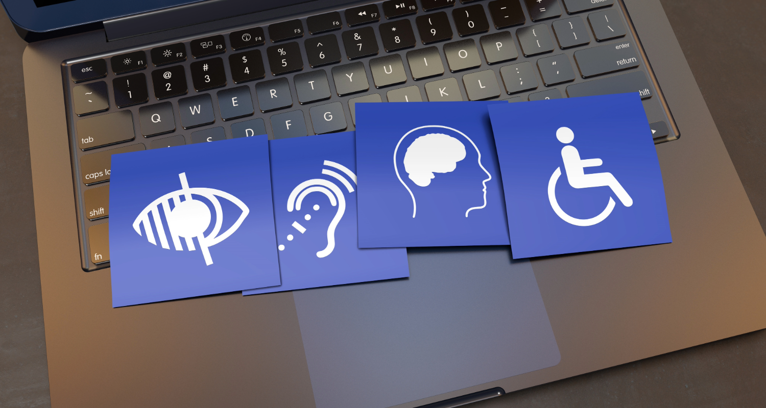 Accessibility symbols refencing visual, auditory, cognitive and motor impairments, lay across a laptop keyboard
