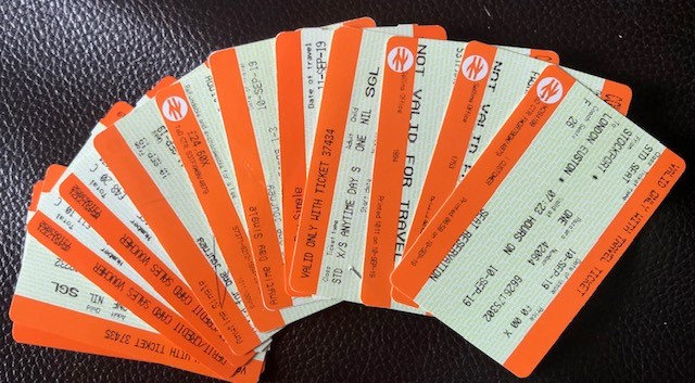 A stack of train tickets fanned out like playing cards. 