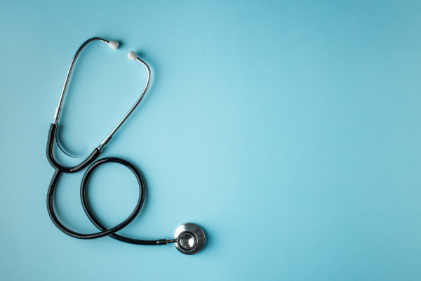 A coiled stethoscope on a blue background