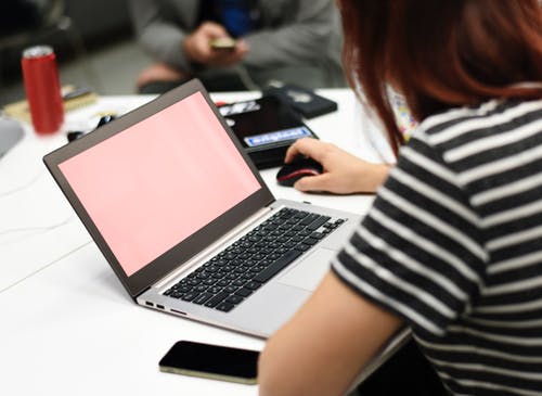 Person using a laptop on a desk in the office